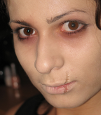 [stock photo of a person wearing zombie makeup]