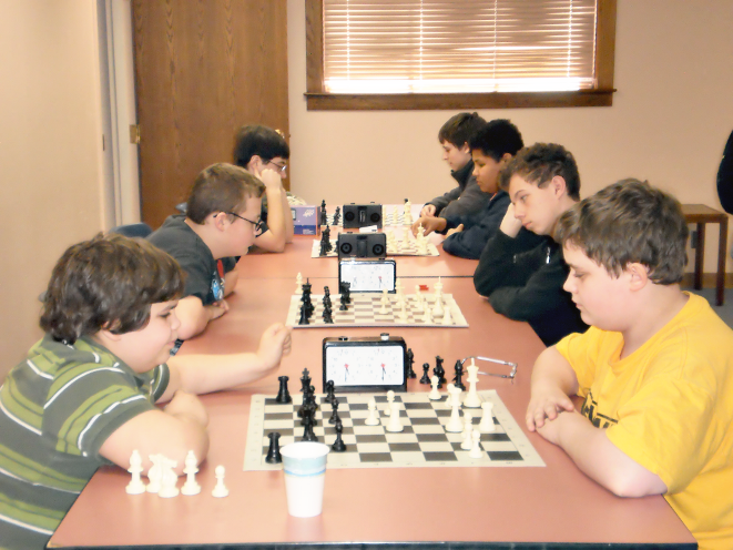 [photo of teens playing chess]