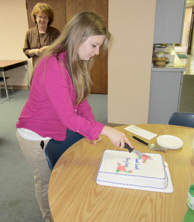 [photo - young woman cutting a cake]