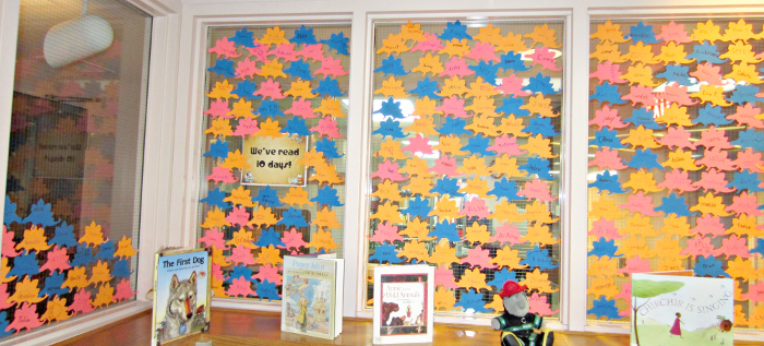 [photo: for each child who read 10 days, a stegosaurus outline with the child's name was placed on the windows]
